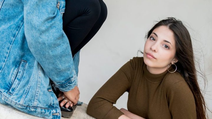 Deux amis comparent leurs tenues streetwear dans une rue urbaine.
